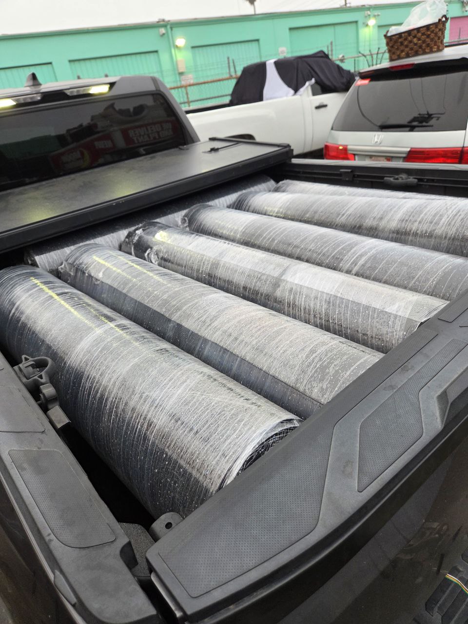 Rubber flooring rolls being prepared for shipping